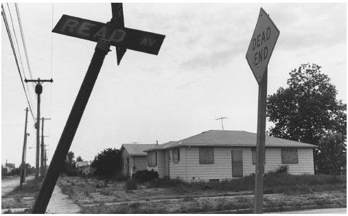 Weeds grow around boarded up homes in Love Canal, New York in 1980. (Corbis-Bettmann. Reproduced by permission.) 